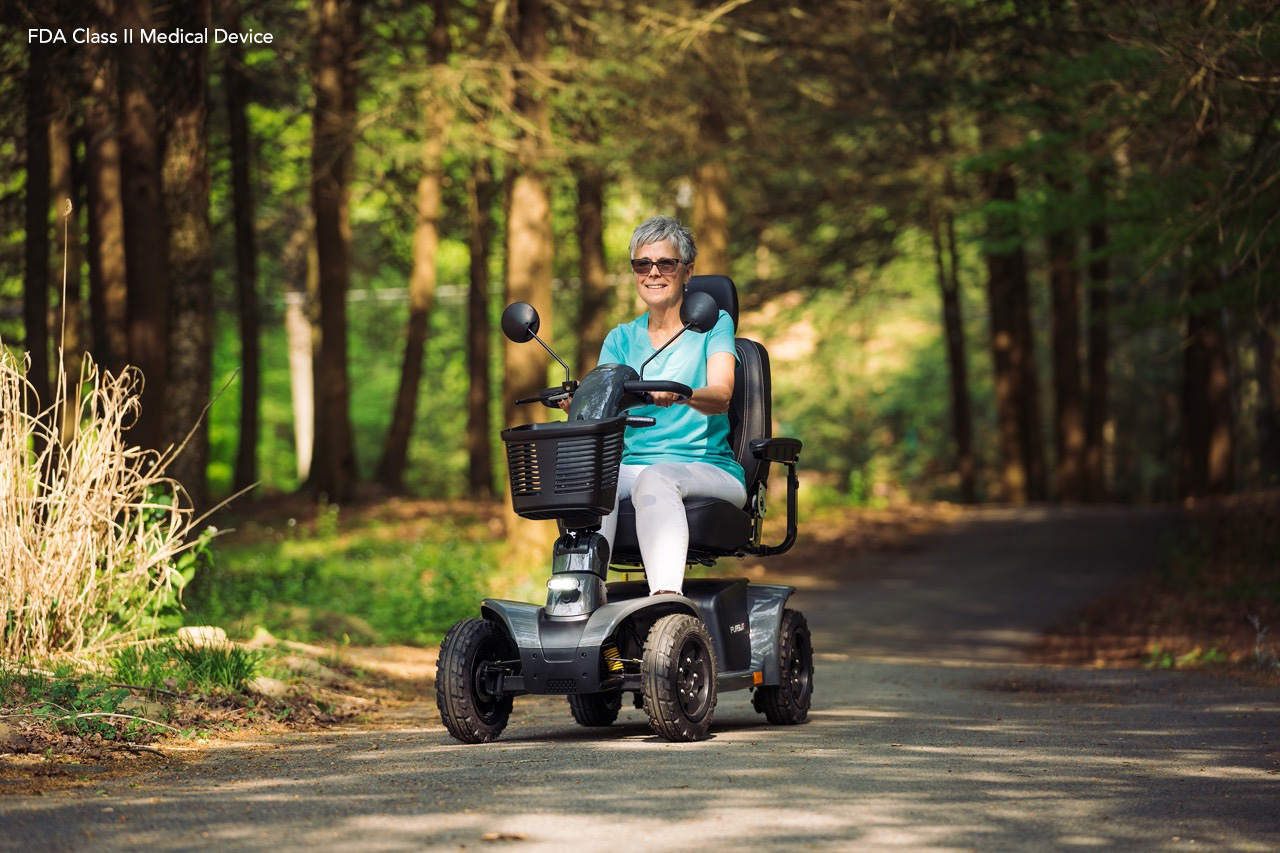 Happy customer riding her mobility scooter outdoors after a repair